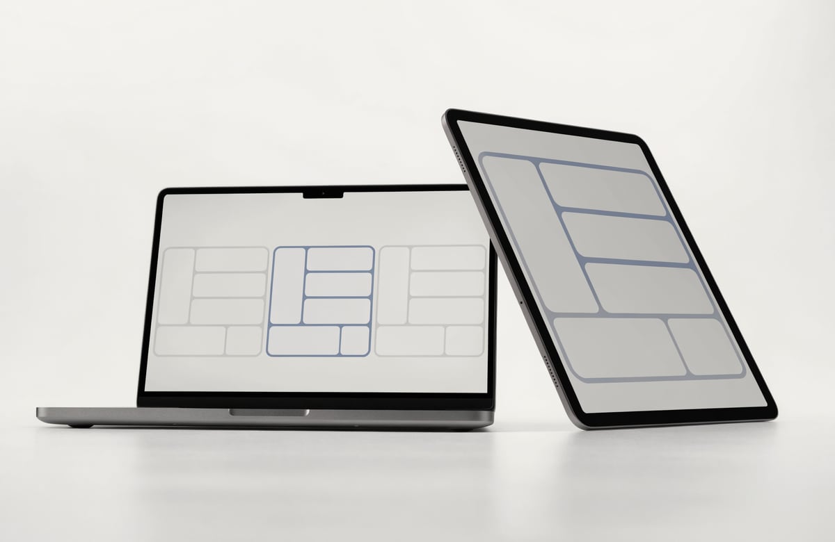 Product photograph: a laptop showing several candidate interface layouts side by side with one selected, and a tablet beside it showing that layout resolved into a full workspace.
